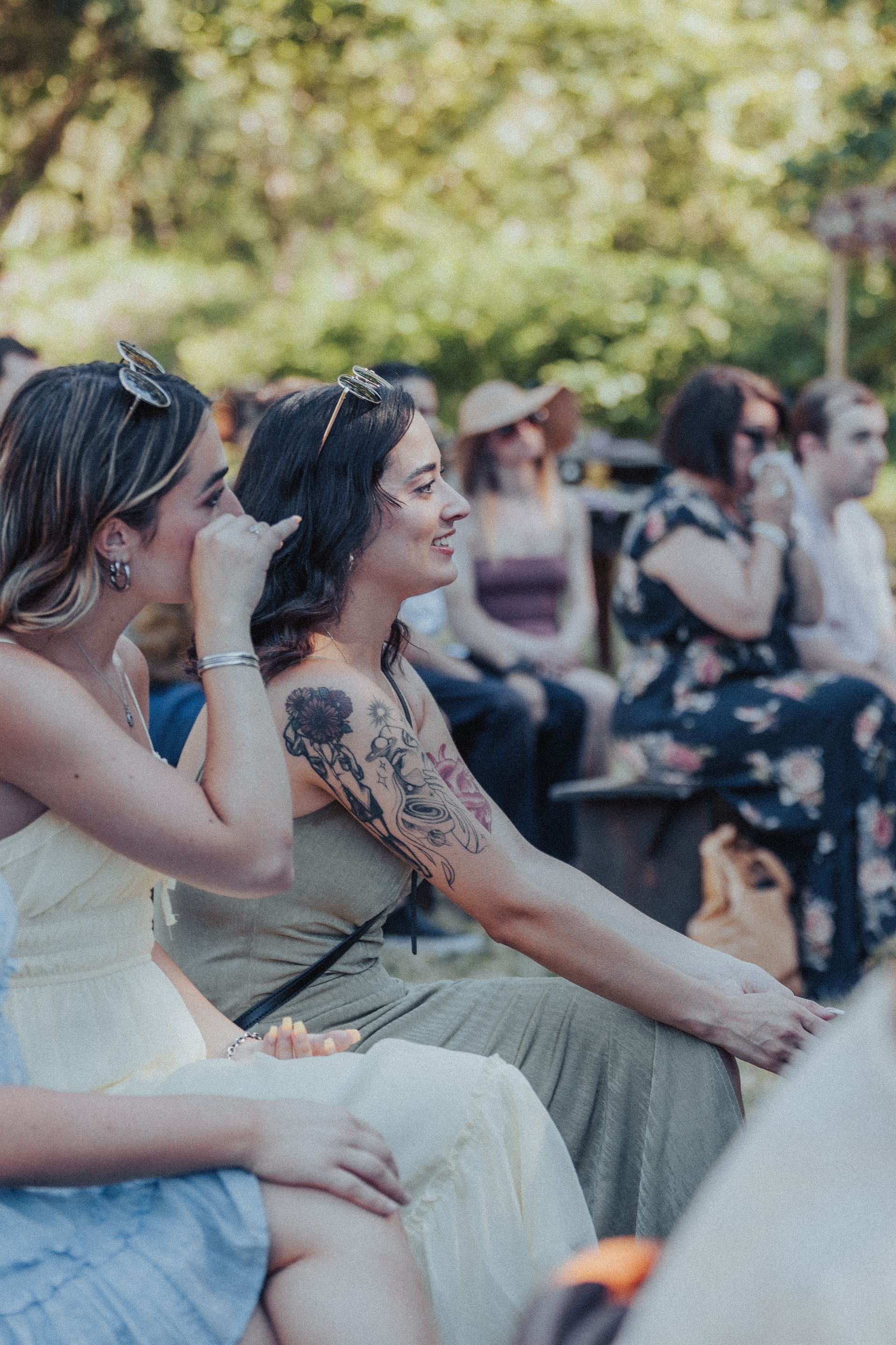 A group of women are sitting around a campfire.