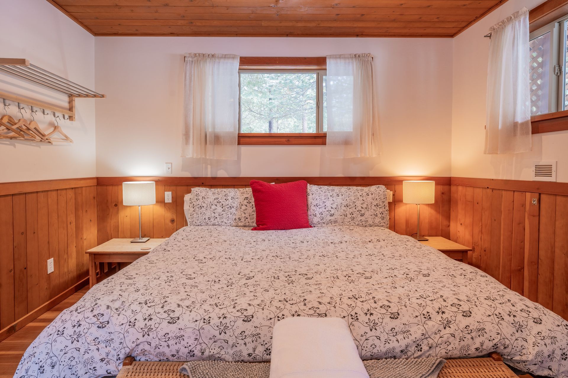 A bedroom with a king size bed and a window.