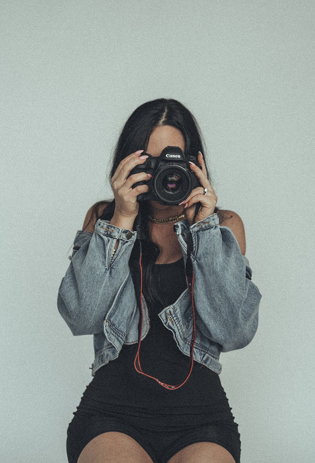 A woman is taking a picture of herself with a camera.