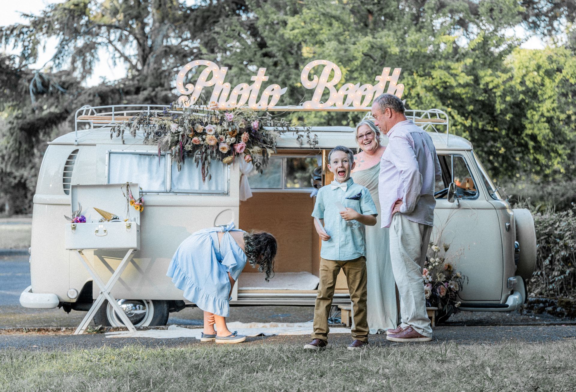 A family is standing in front of a photo booth.