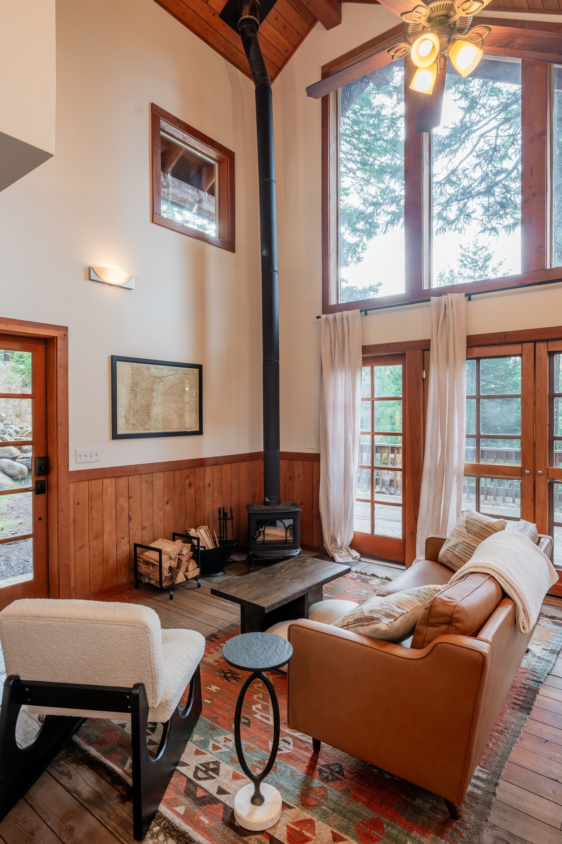 A living room with a couch , chairs , and a fireplace.