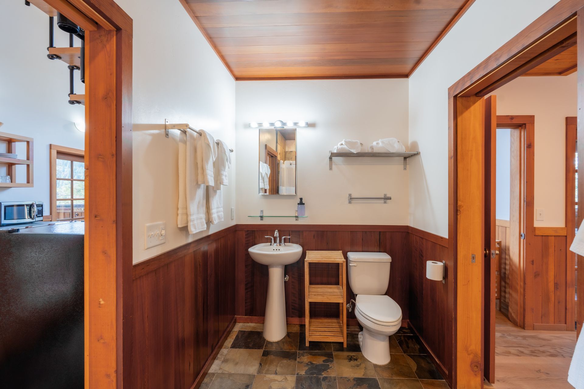 A bathroom with a sink , toilet and mirror.