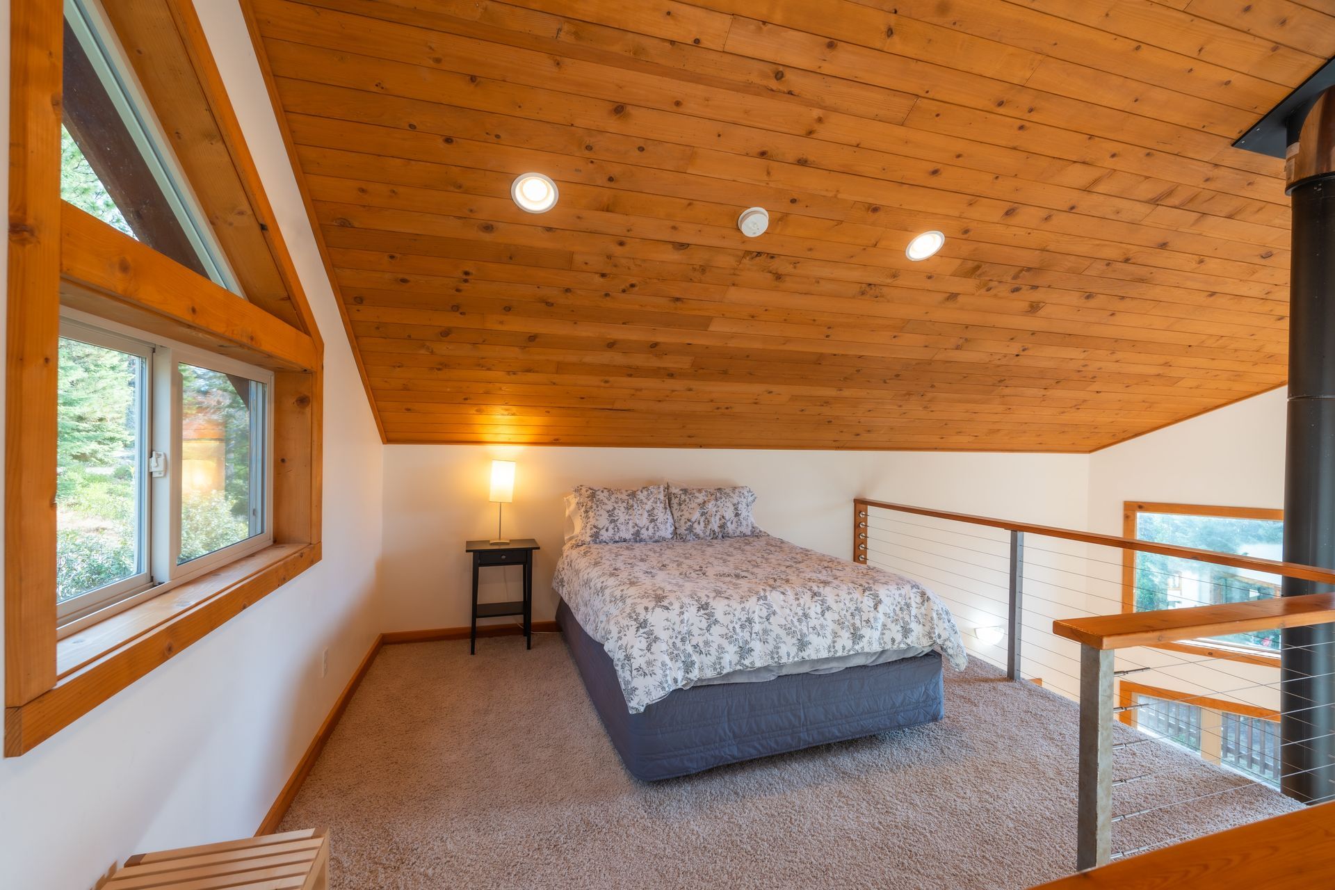 There is a bed in the attic of a house.