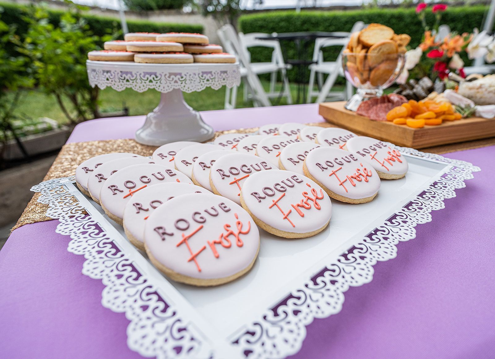 A tray of cookies on a table with a purple table cloth.