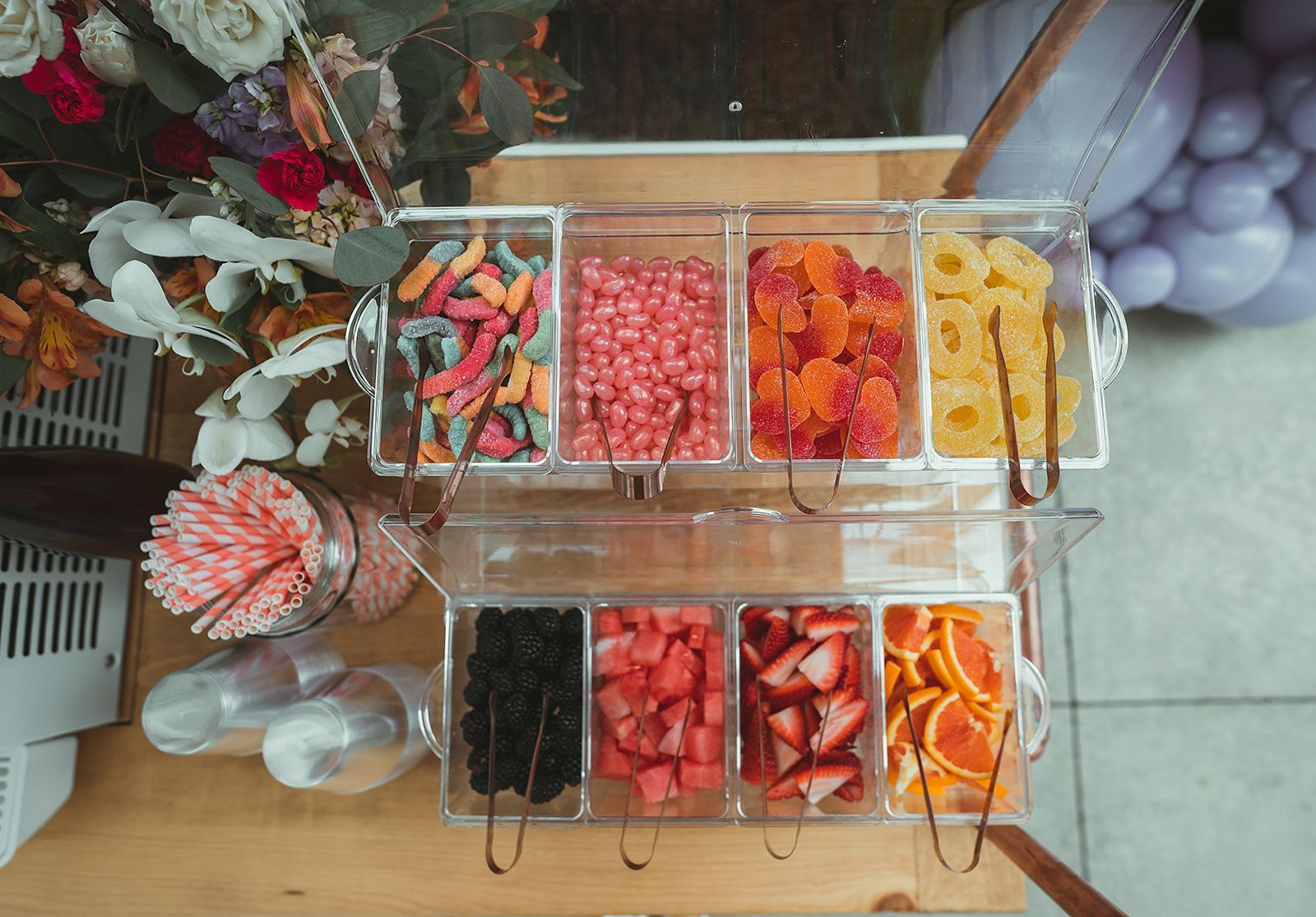 A table topped with a variety of candy and fruit.