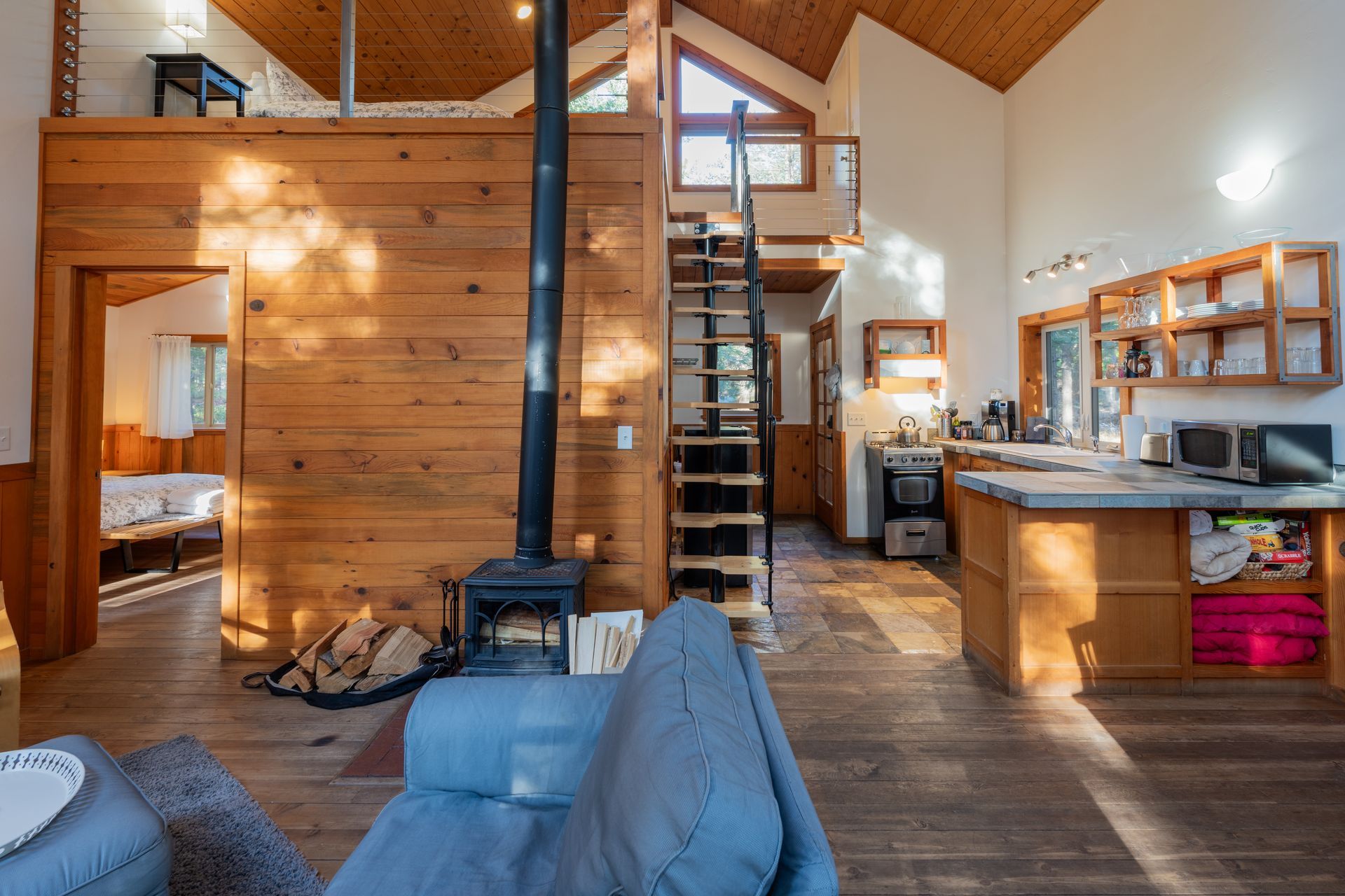 A living room with a couch and a fireplace in a cabin.