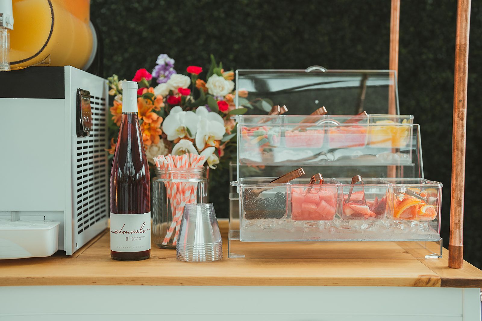 A bottle of wine is sitting on top of a wooden table.