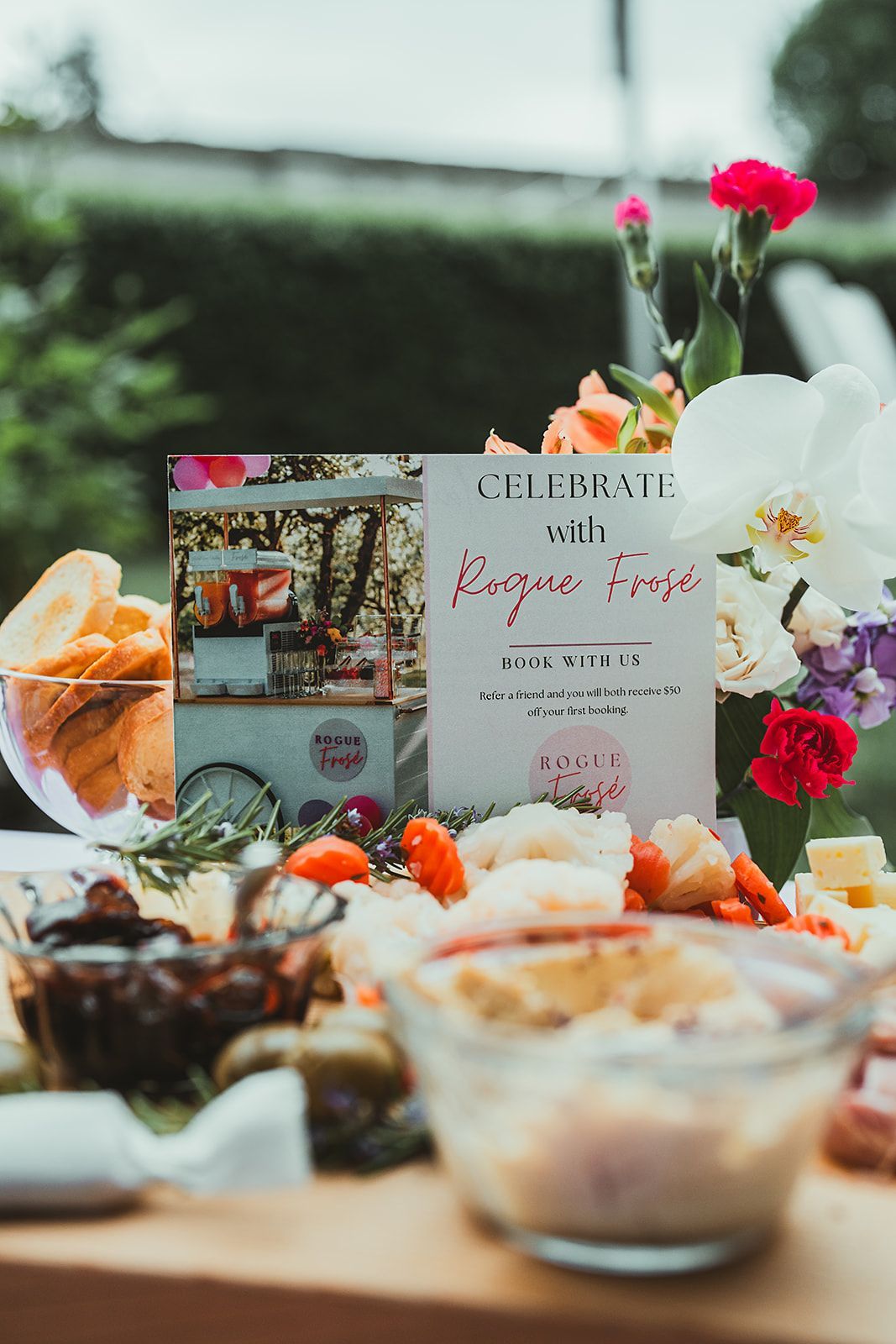 A table topped with a variety of food and a sign.