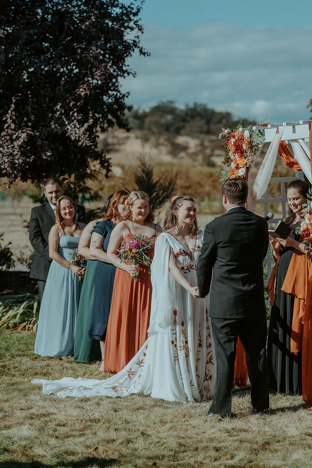 A bride and groom are holding hands during their wedding ceremony.
