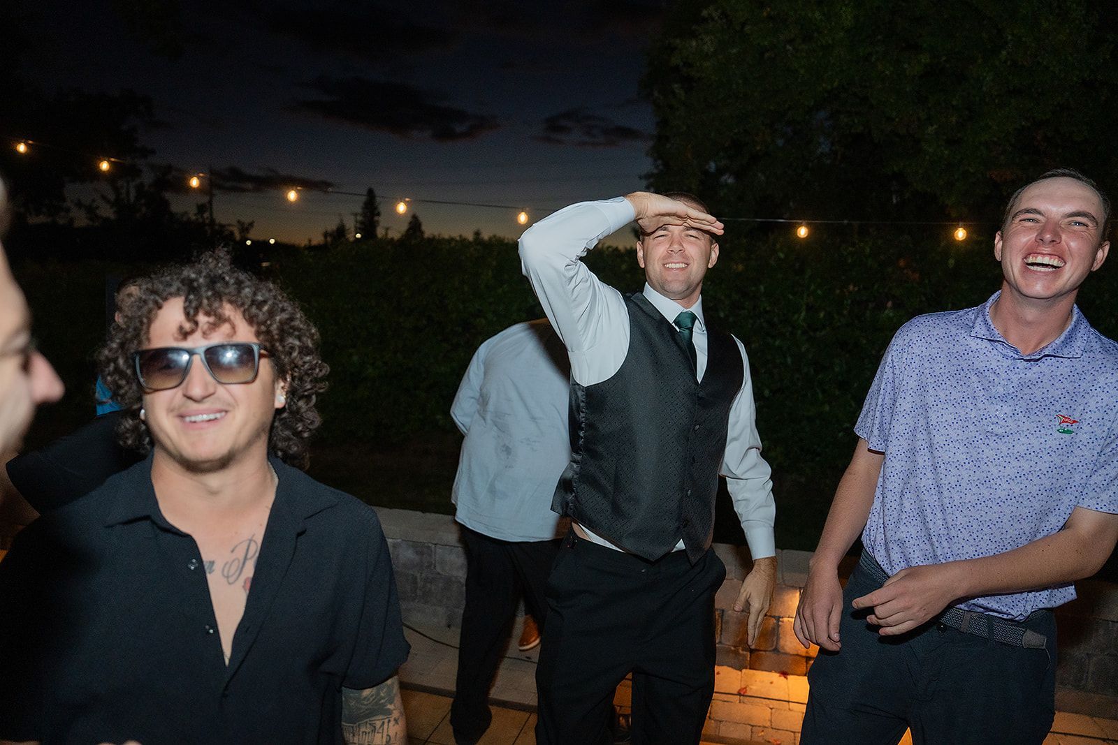 A group of men are standing next to each other and smiling.