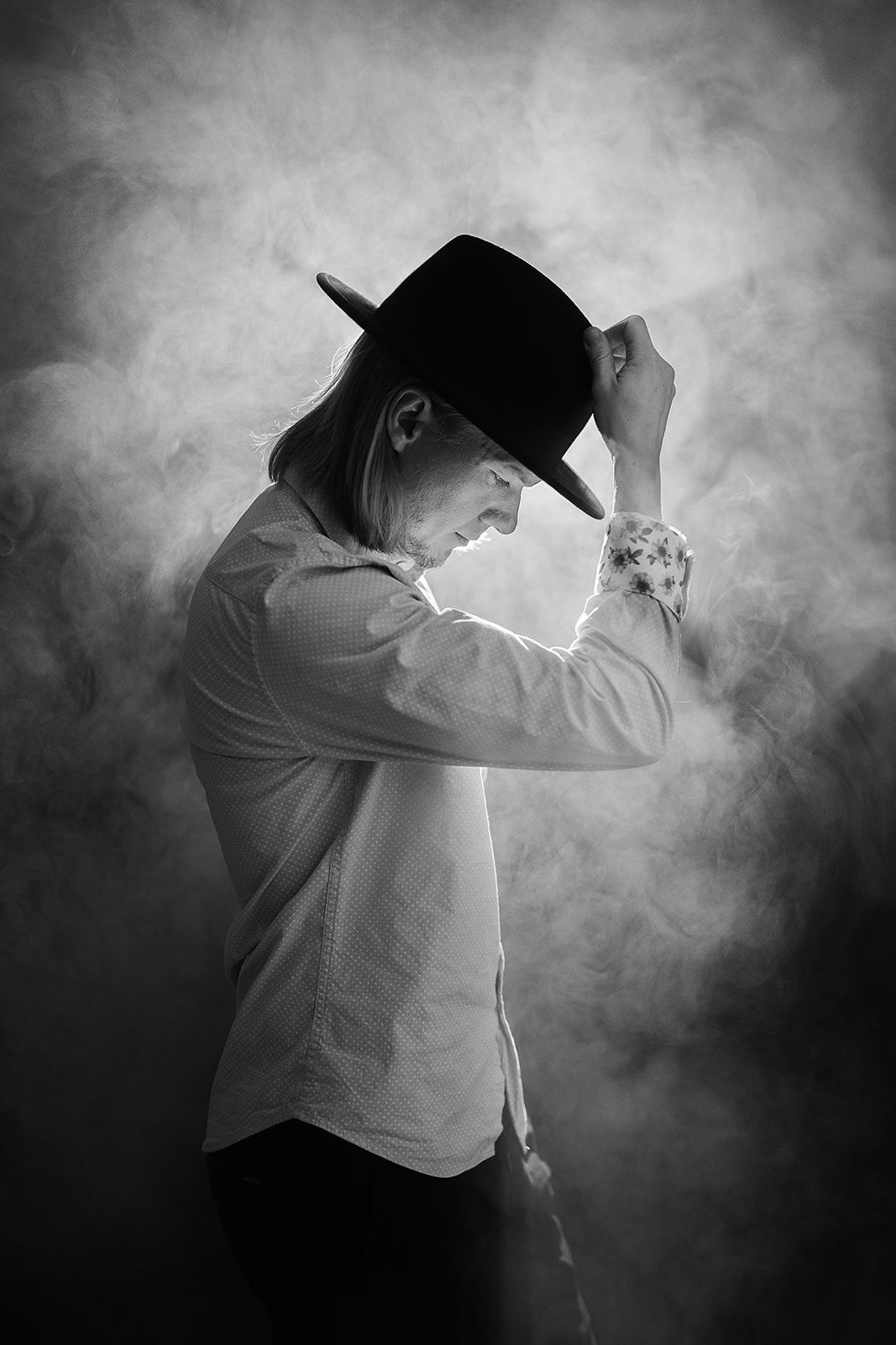 A black and white photo of a man wearing a cowboy hat.