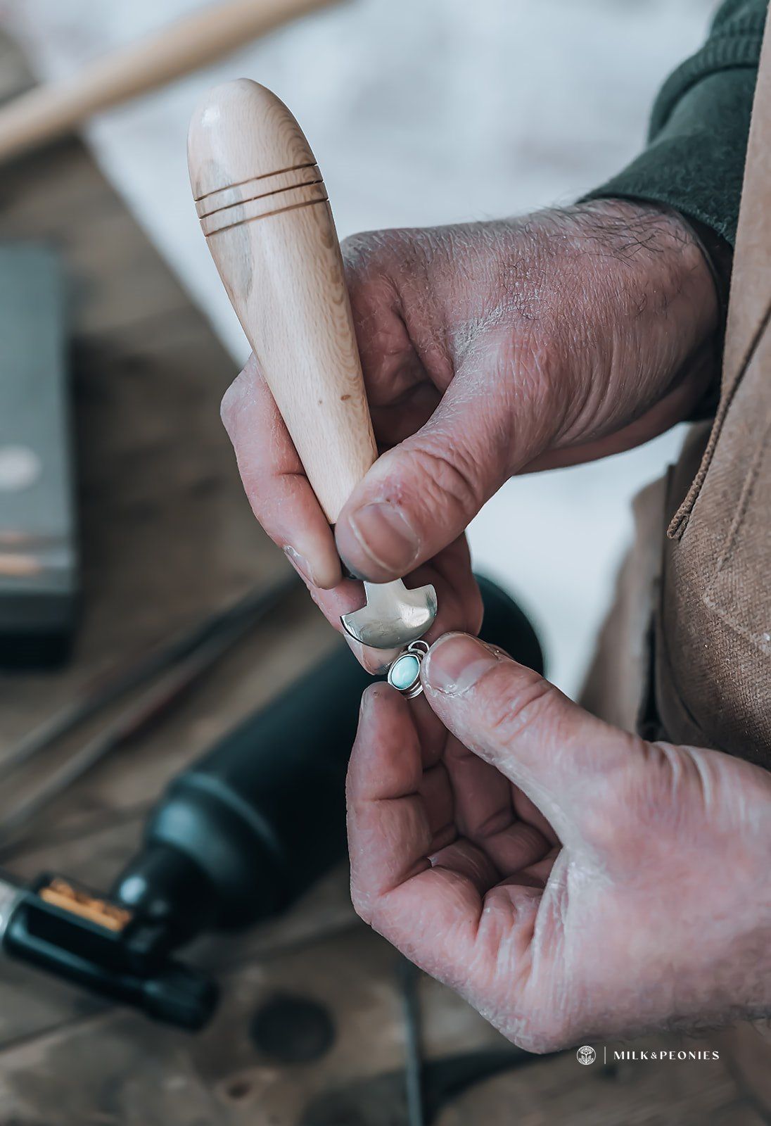 A person is holding a piece of wood in their hands.