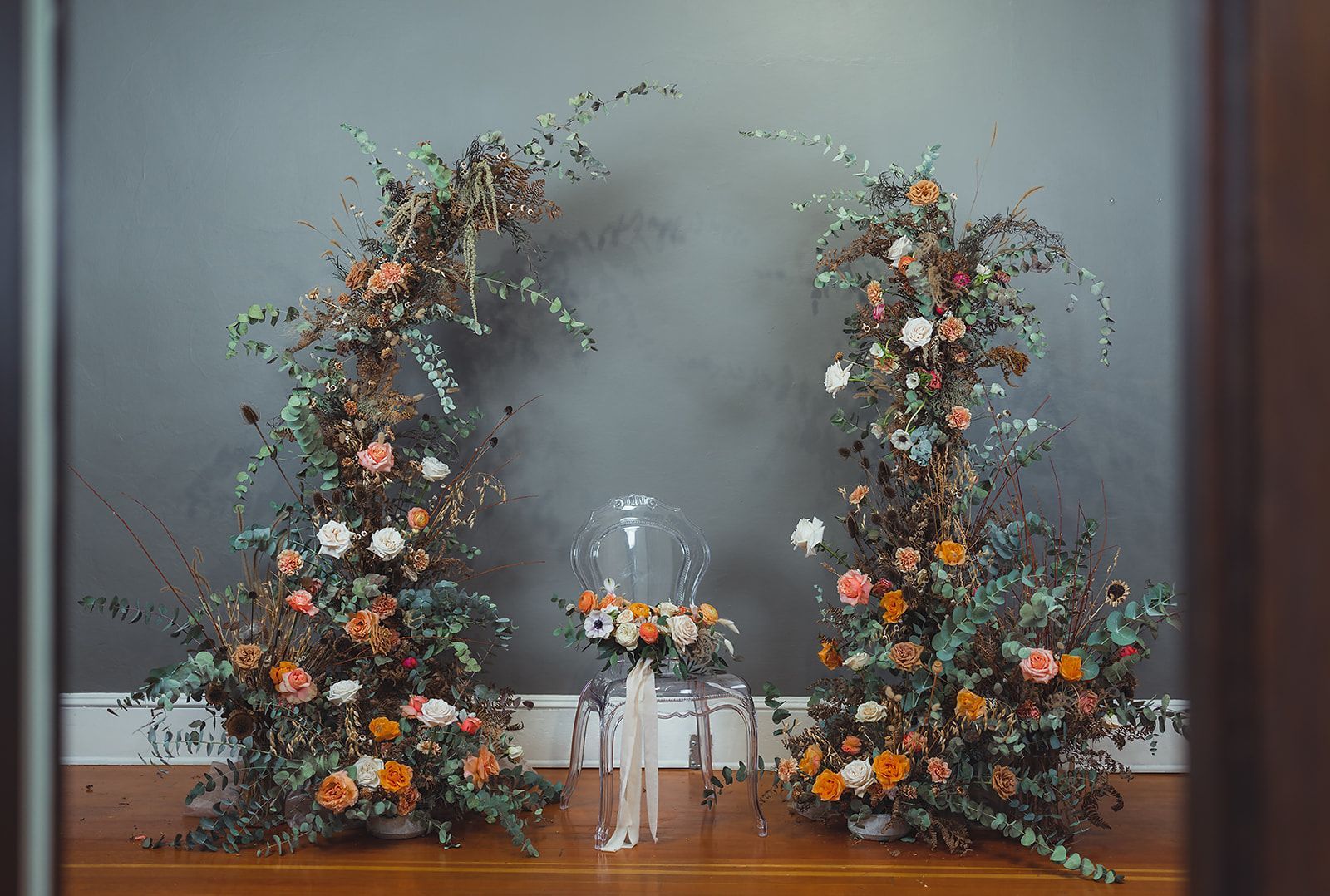 A couple of flowers sitting on top of a wooden table.