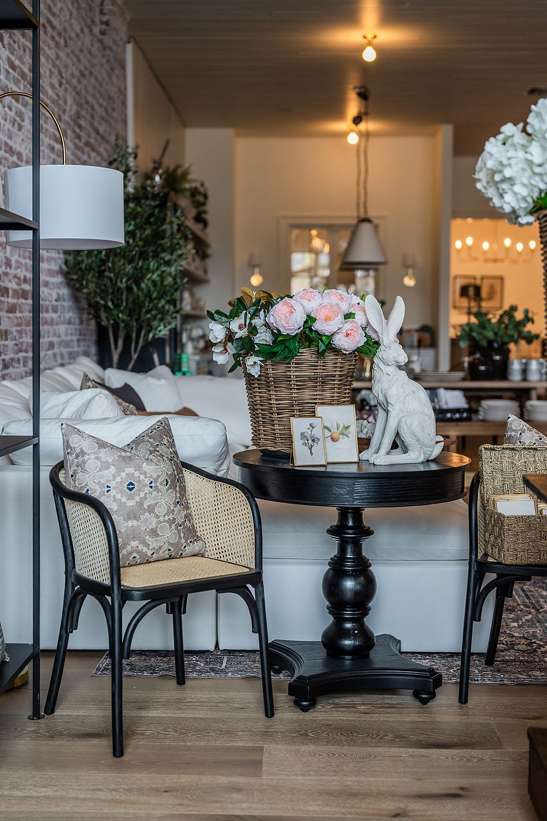A living room filled with furniture and a table with a rabbit on it.