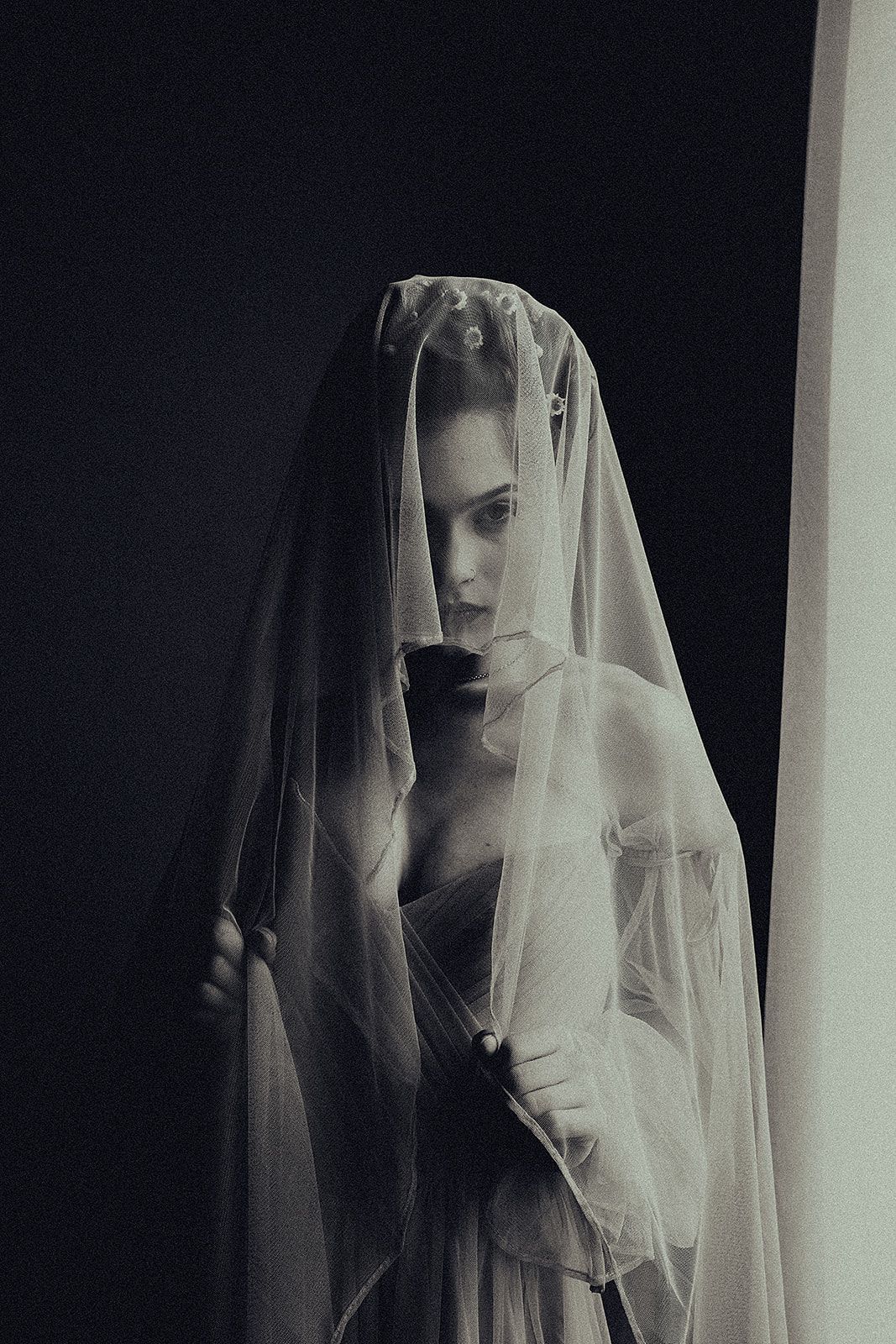 A woman in a veil is taking a picture of herself