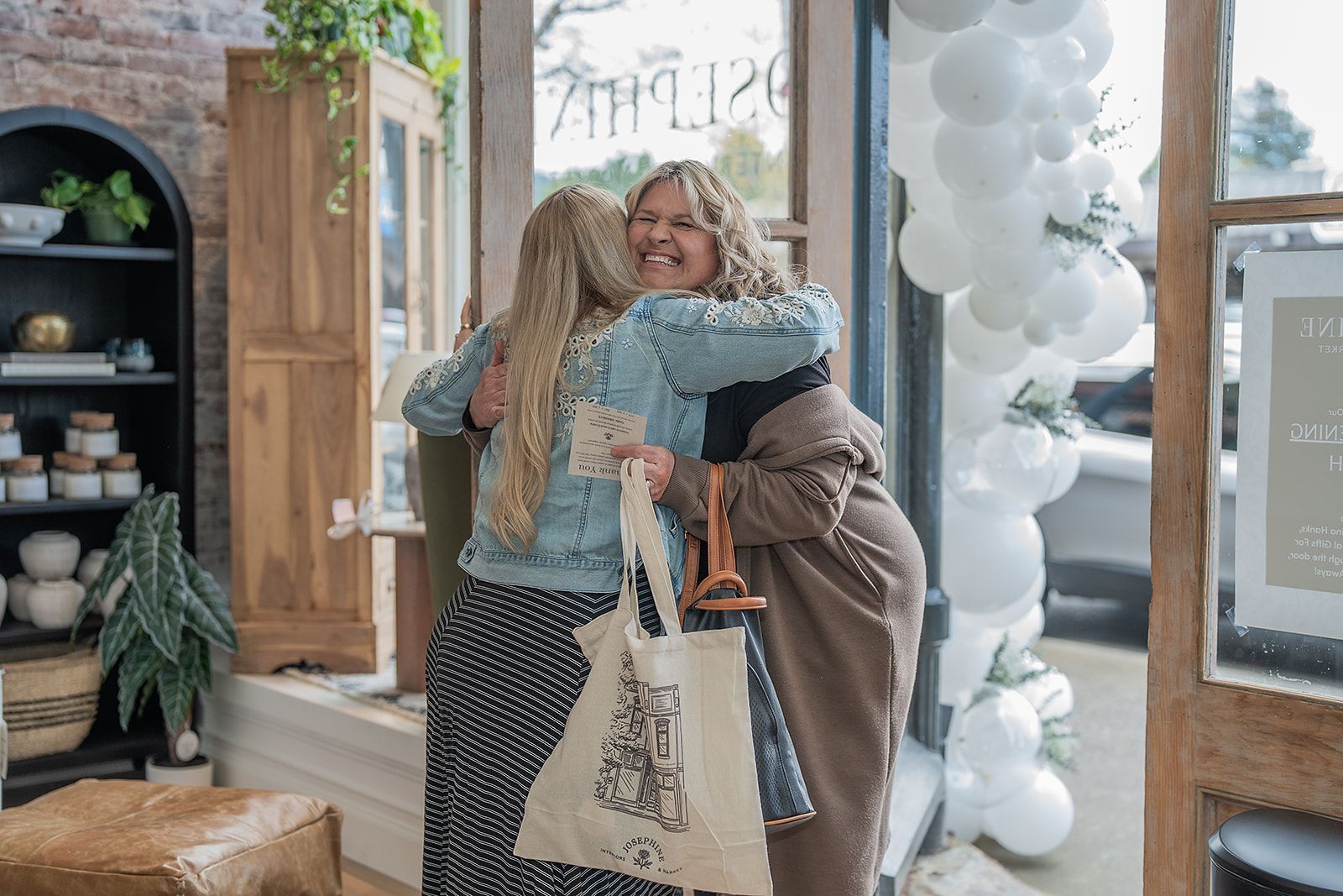 Two women are hugging each other in a store.
