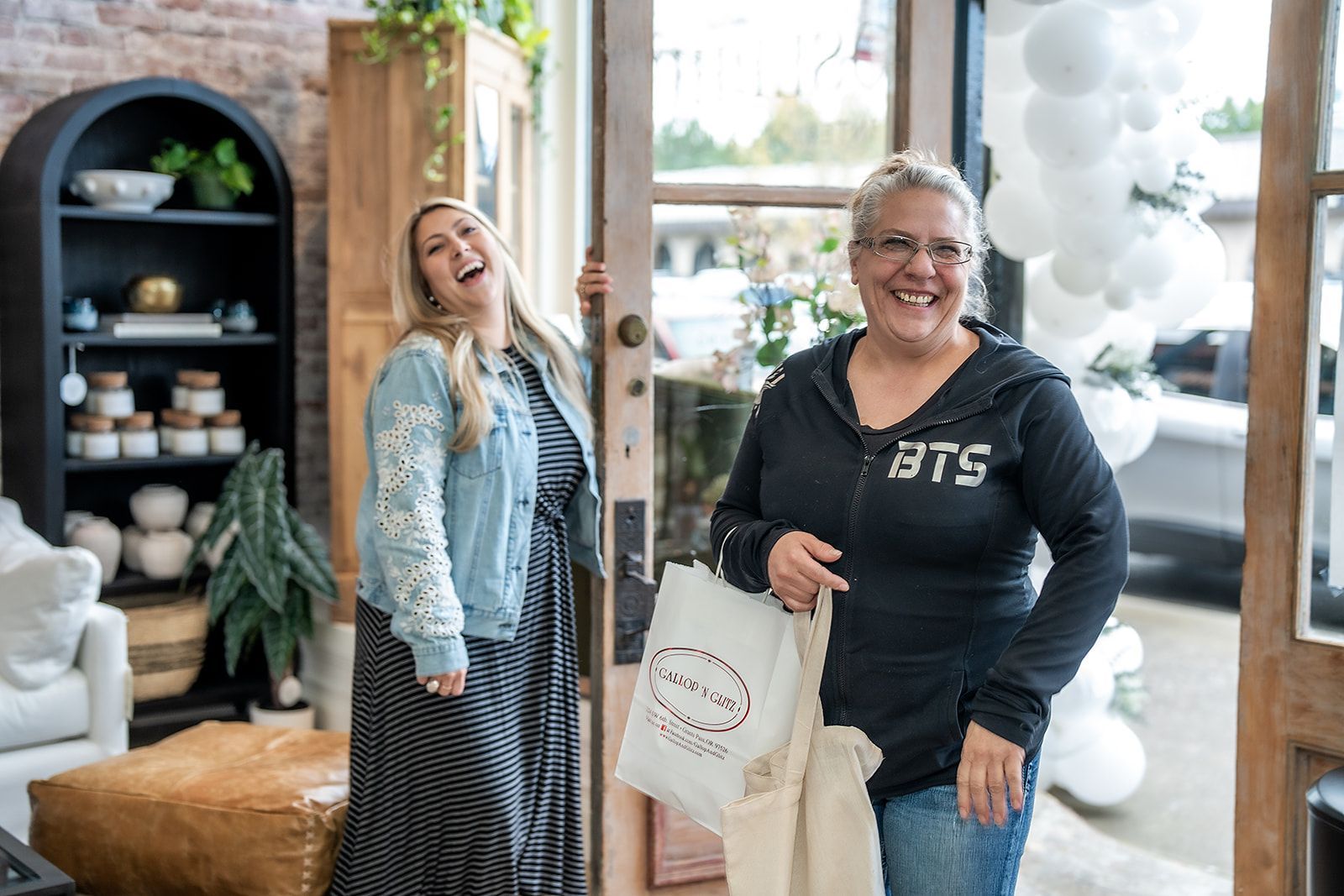 Two women are standing next to each other in a store.
