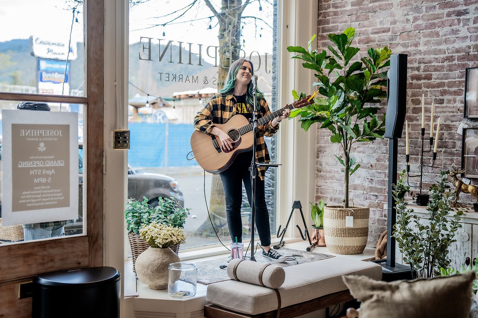 A woman is playing a guitar in a living room.
