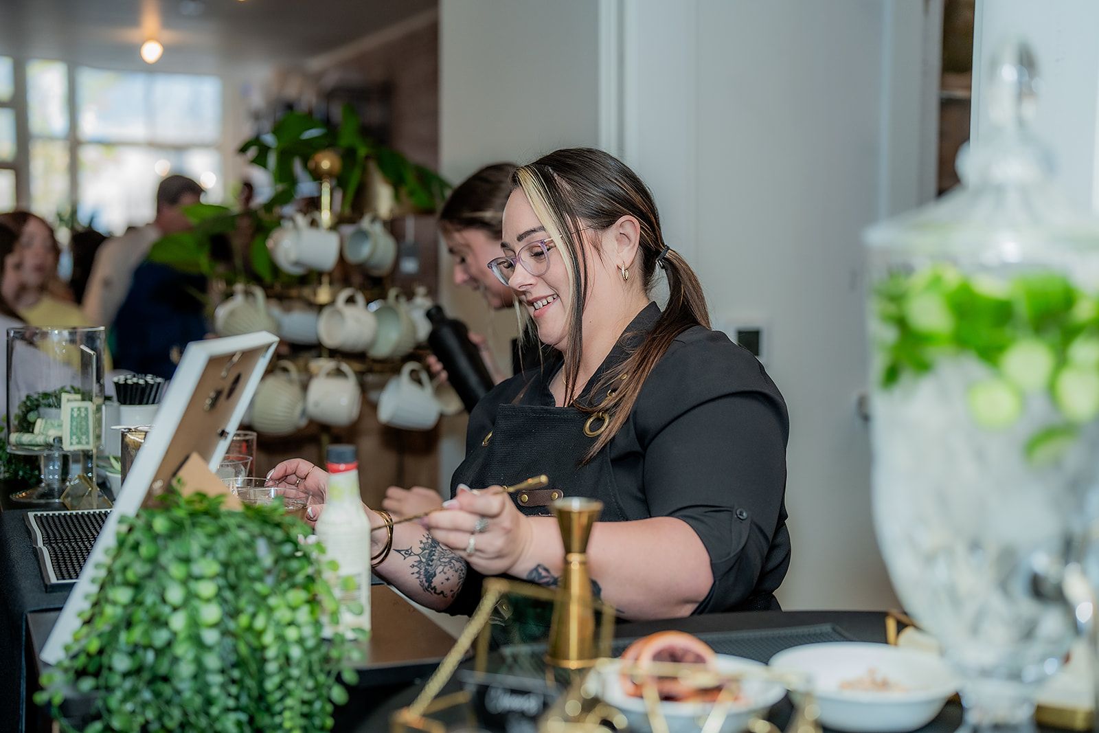 A woman is sitting at a counter in a restaurant.