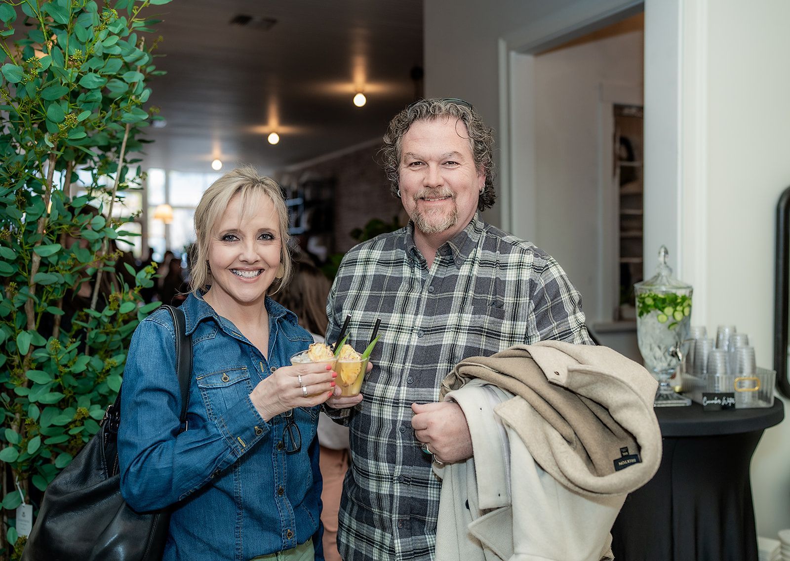 A man and a woman are standing next to each other in a room.