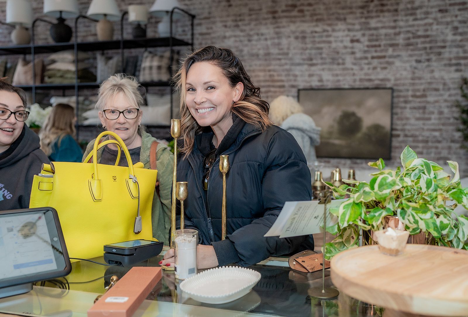 A woman is sitting at a counter in a store.