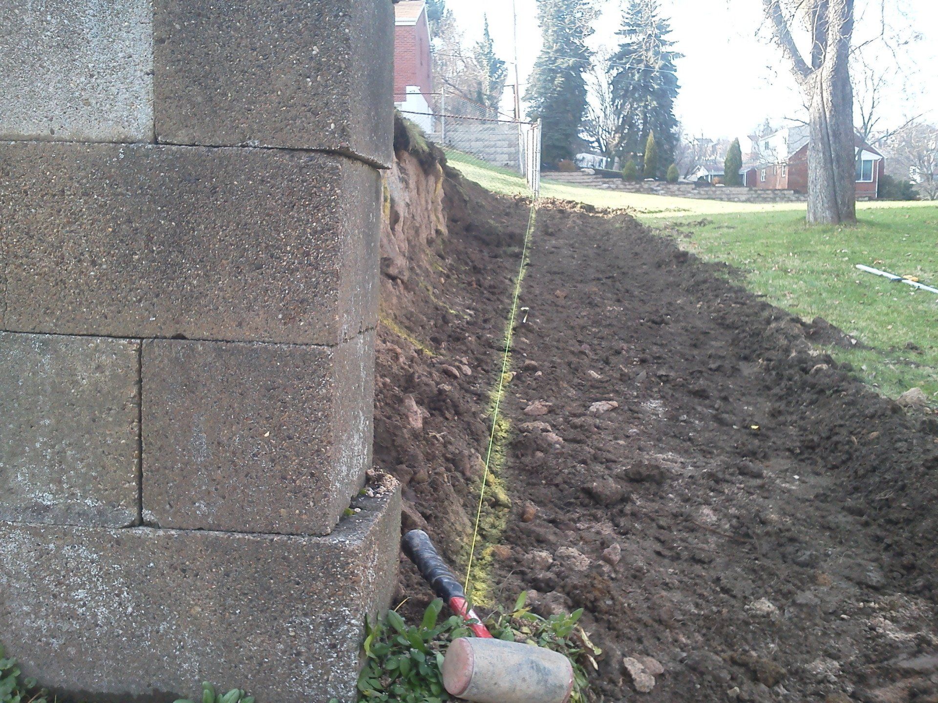 A brick wall is being built in a park