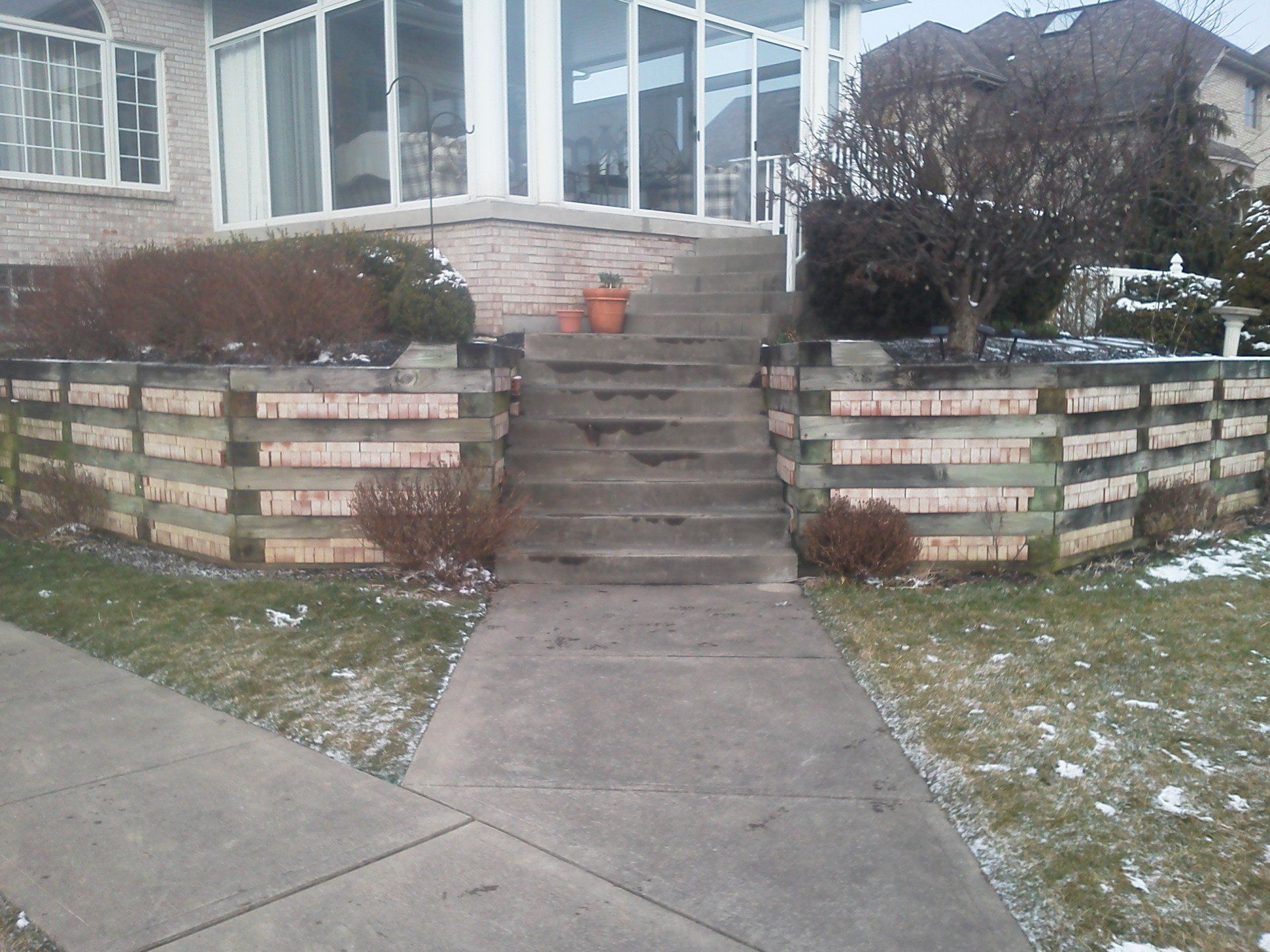 A wooden fence with stairs leading up to a house