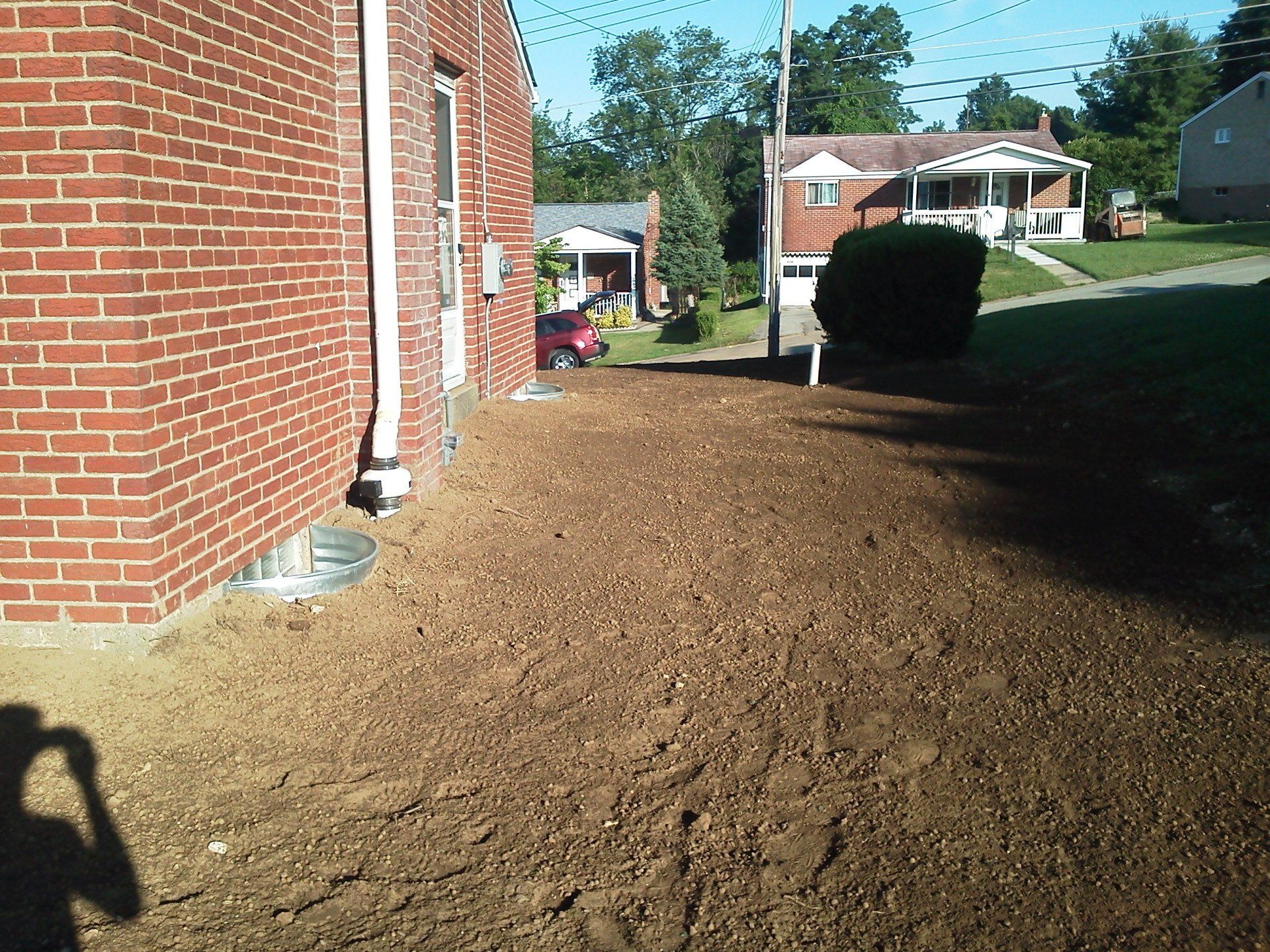 A brick building with a lot of dirt in front of it