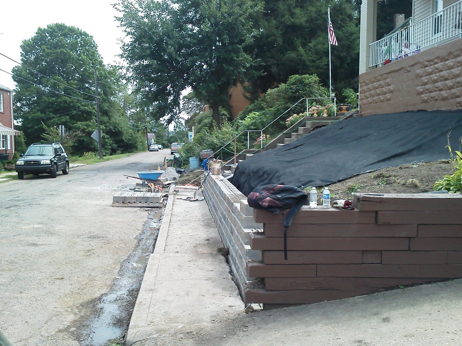 A brick wall is being built in front of a house