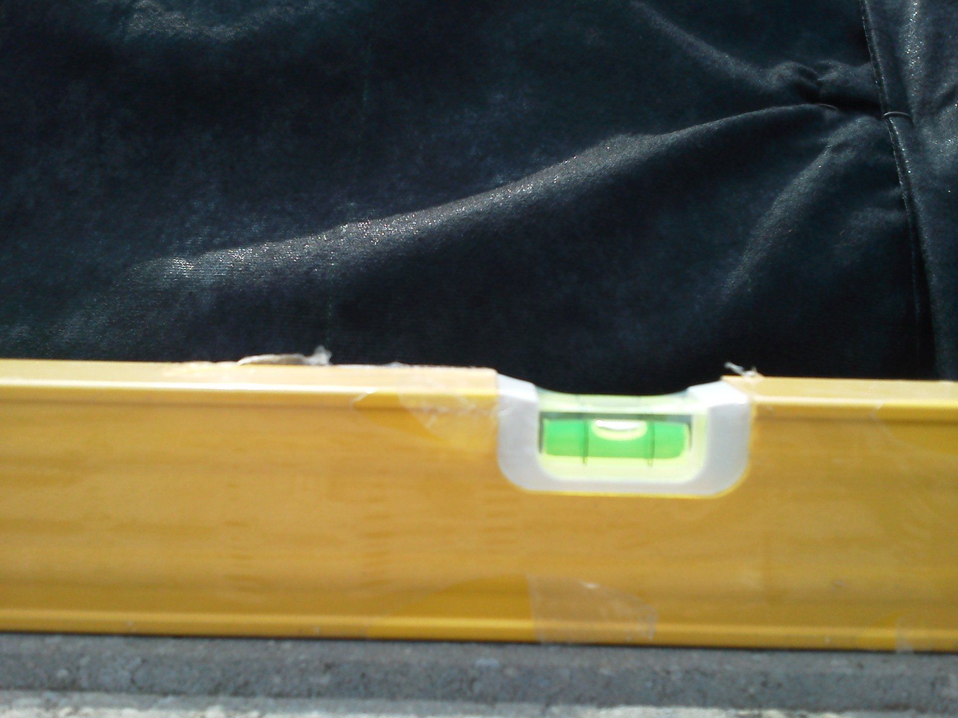 A wooden level with a green liquid in it
