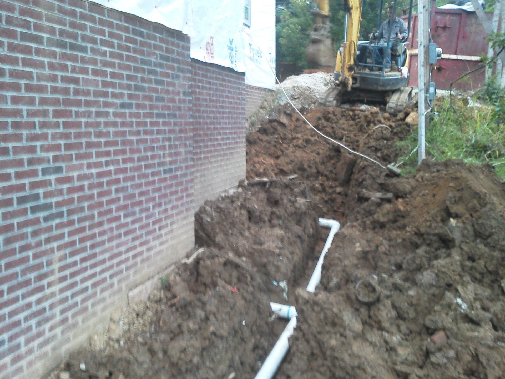 A construction site with a brick wall in the background