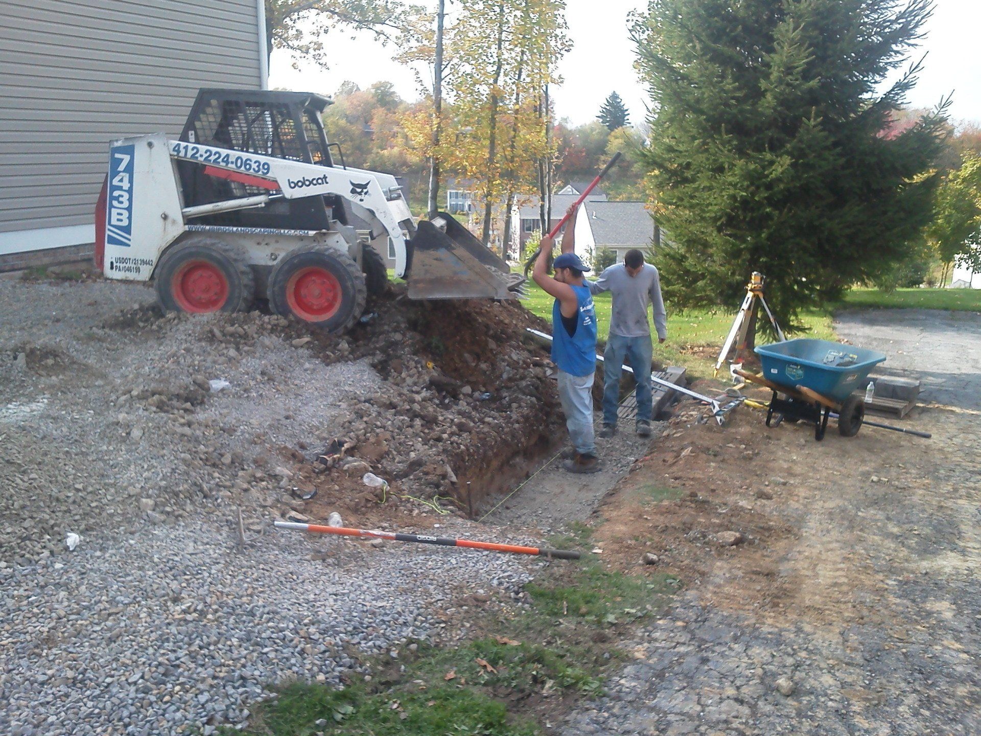 A bobcat is being used to dig a hole in the ground
