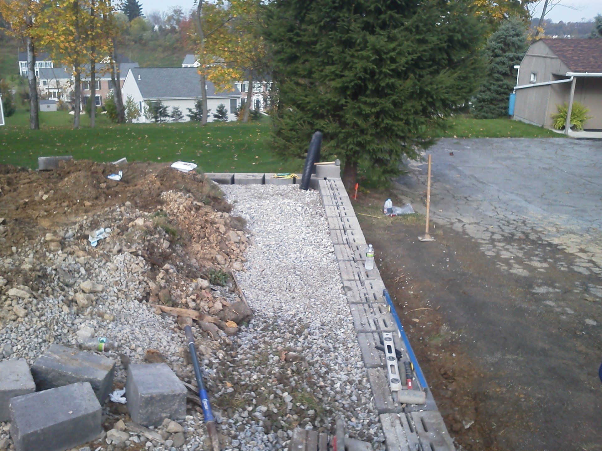 A brick wall is being built in front of a house
