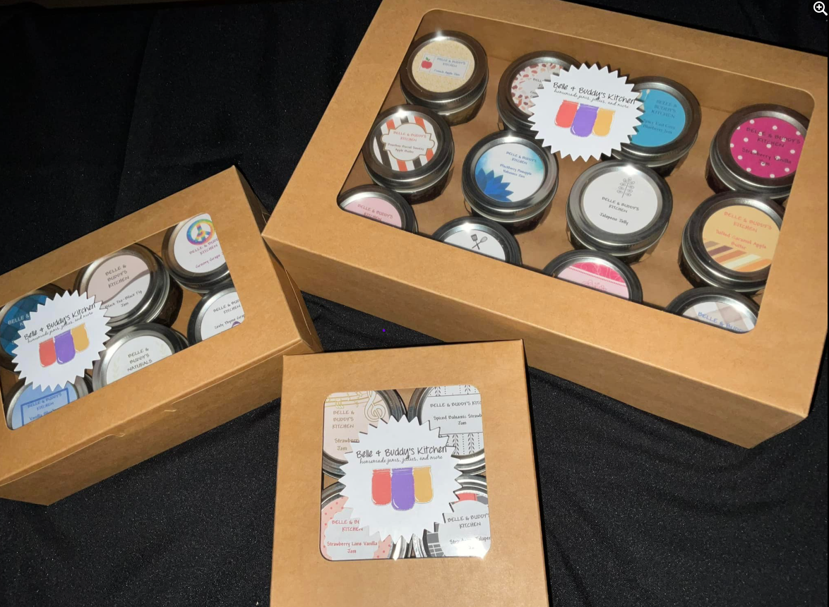 Three boxes filled with jars of different colored candles