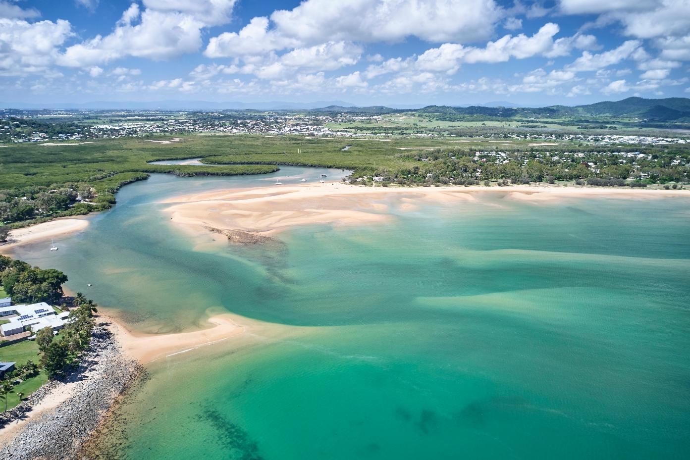 Aerial View of a Large Body of Water With a Sandy Beach — G & A Glass & Aluminium in Whitsundays, QLD