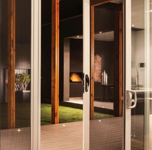 A Man Is Installing A Window In A House — G & A Glass & Aluminium in Cluden, QLD