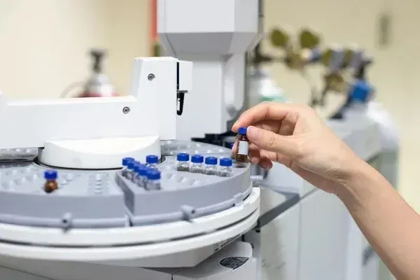 A person is using a machine in a laboratory.
