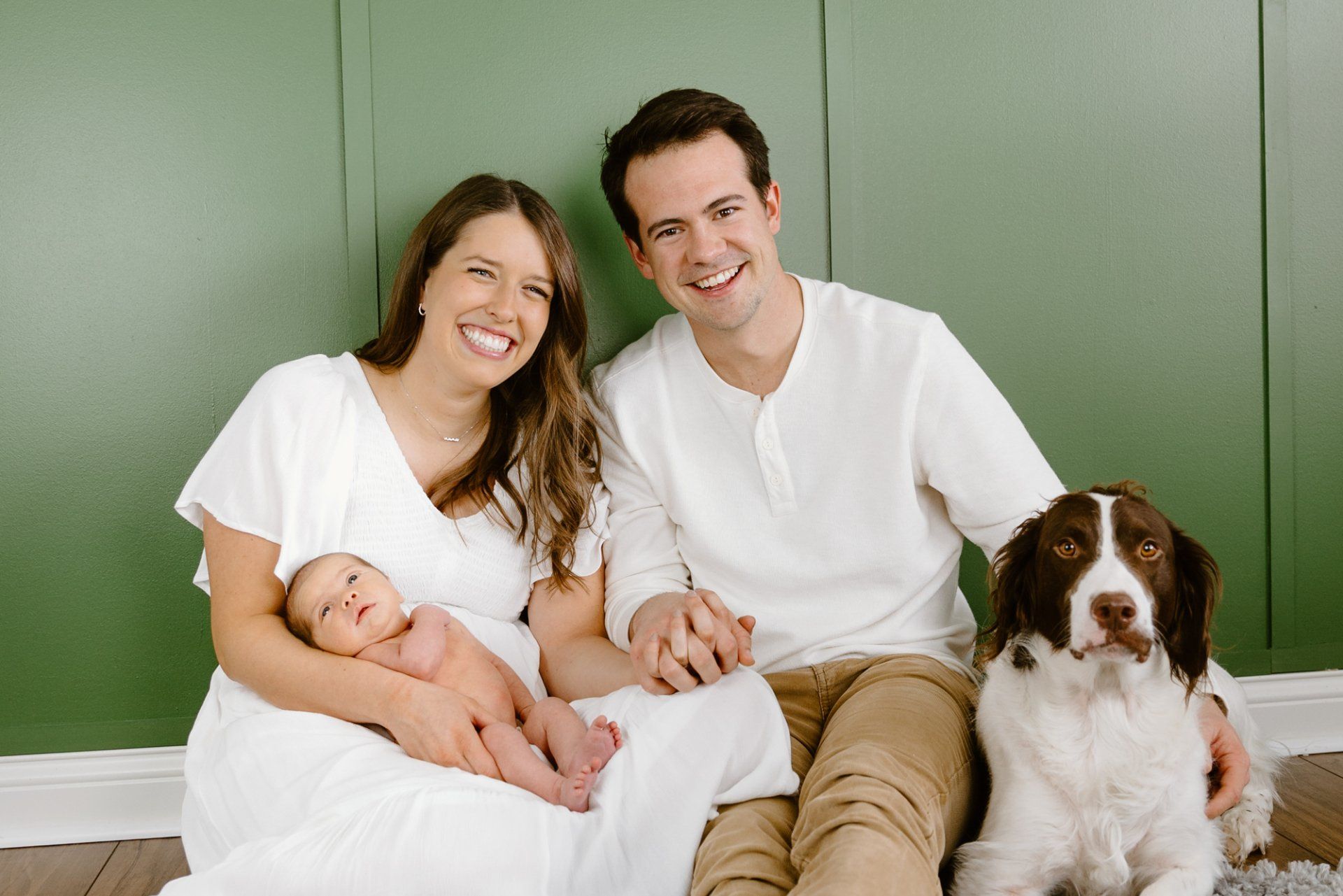 Family portrait with mom, dad, baby and dog