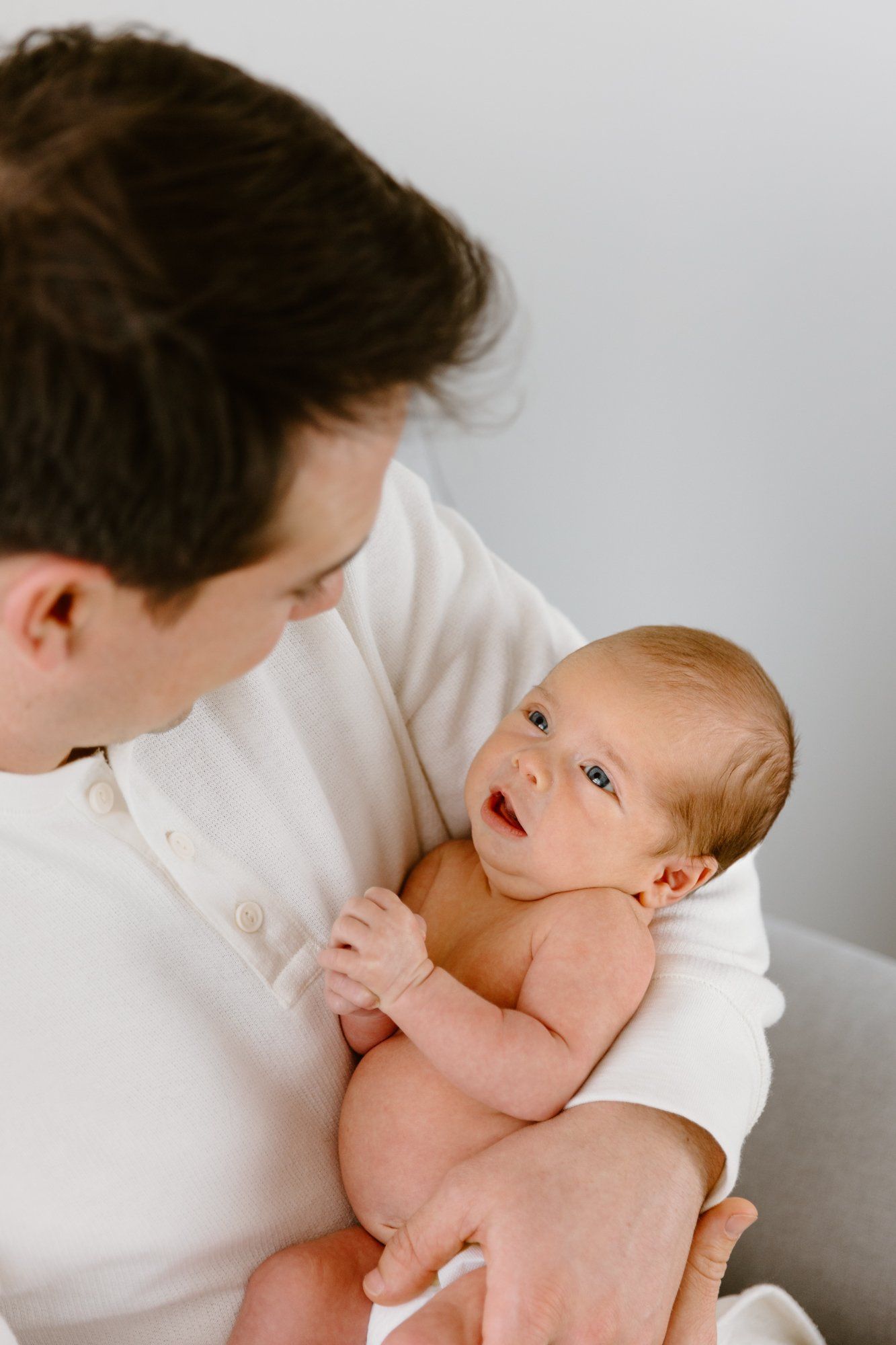 Baby boy looks up at dad