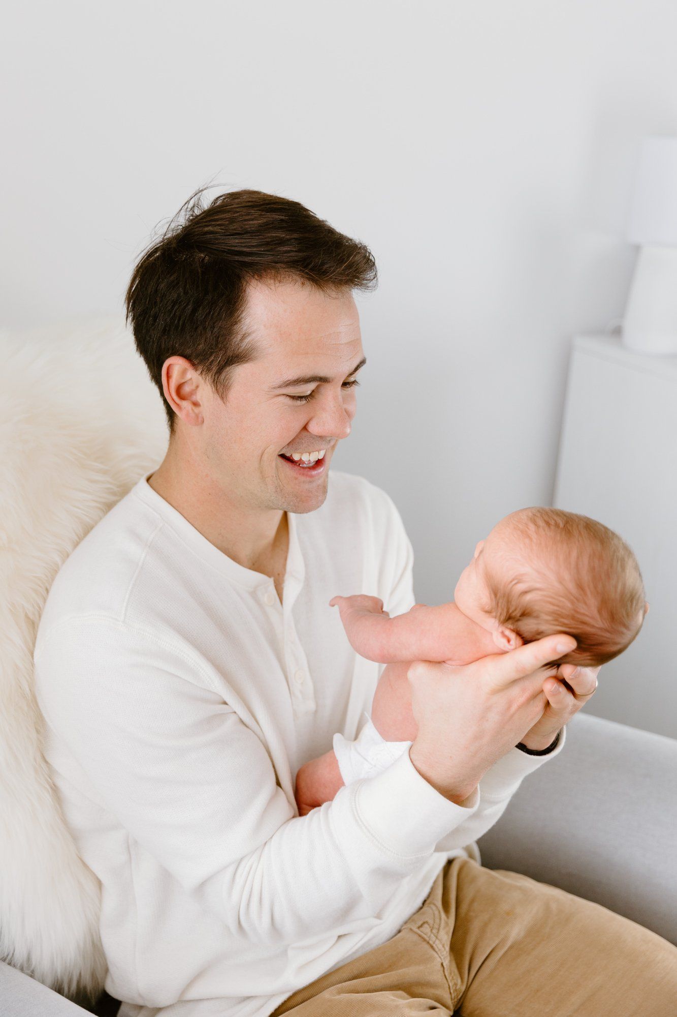 Dad holds up baby and smile
