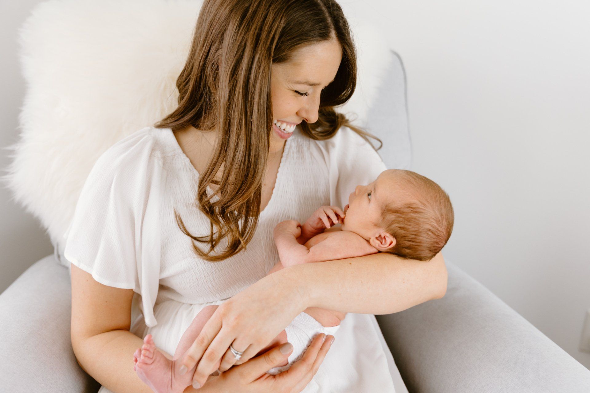 Mom holds her baby as they look at eachother