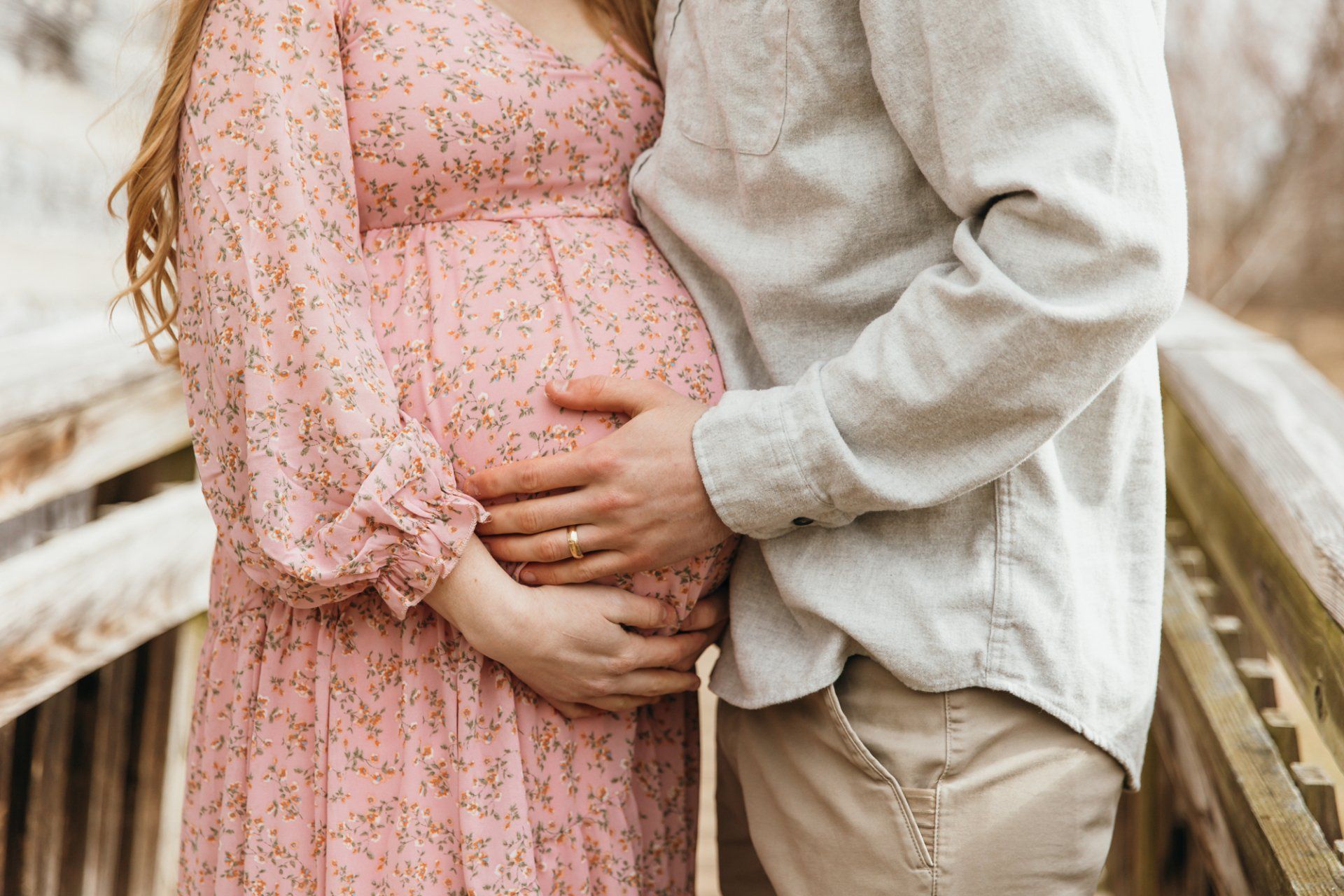 Mom and dad hold their baby bump