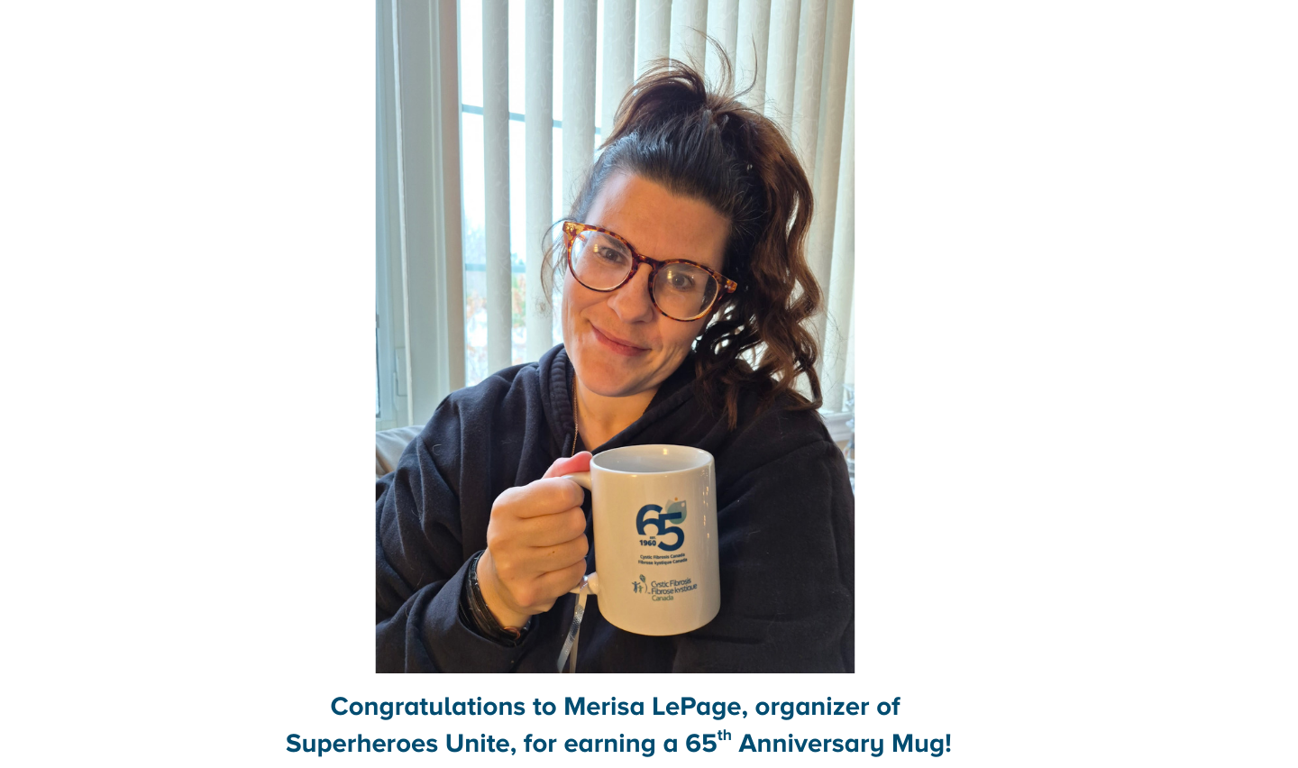 Event organizers holding 65th anniversary mug and thank you card.