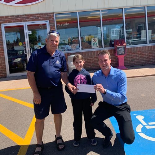 Ron and his grandaughter Josie, holding his donation cheque