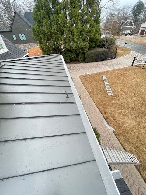 A house with stairs leading up to it is surrounded by trees.