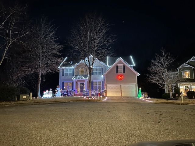 Two men are working on the roof of a house.