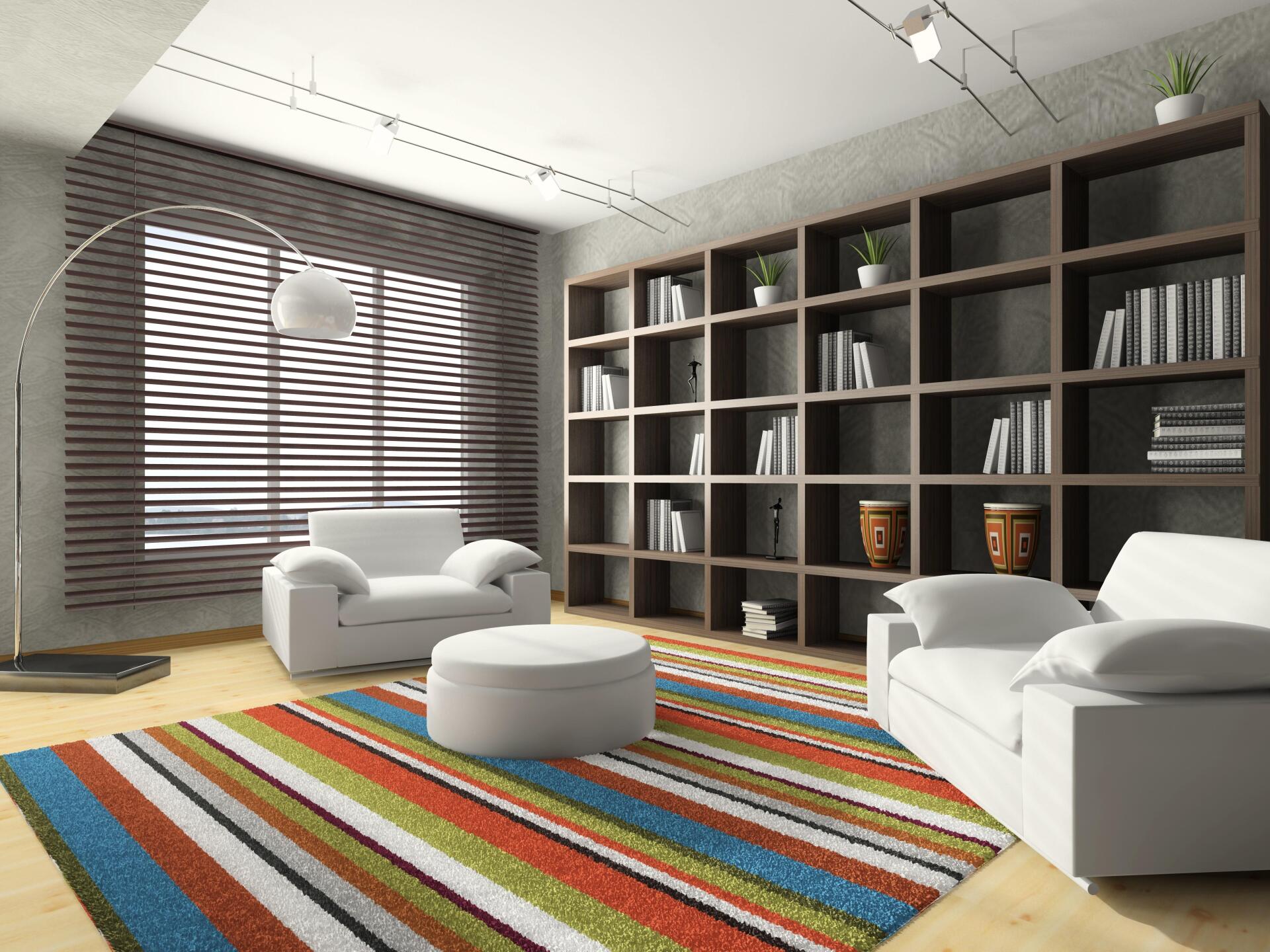 A living room with a couch and chairs and a striped rug