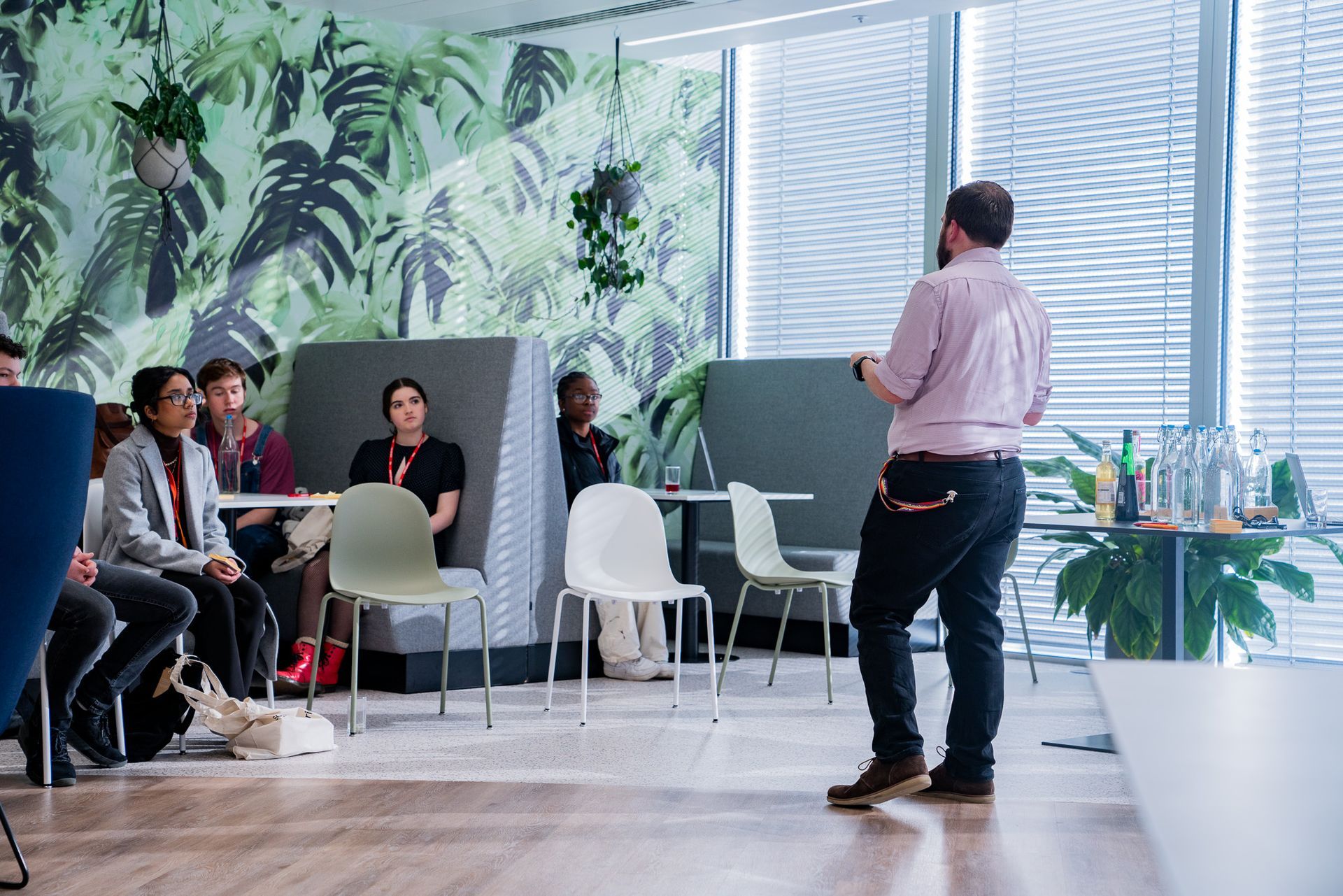 A man is giving a presentation to a group of people in a room.