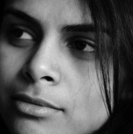A close up of a woman 's face in a black and white photo