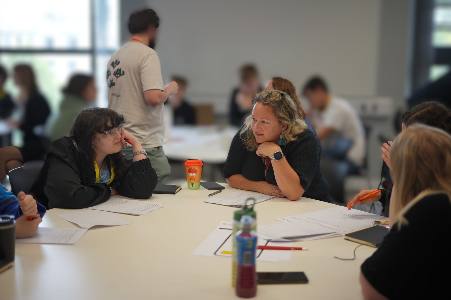 A group of people are sitting around a table in a room.